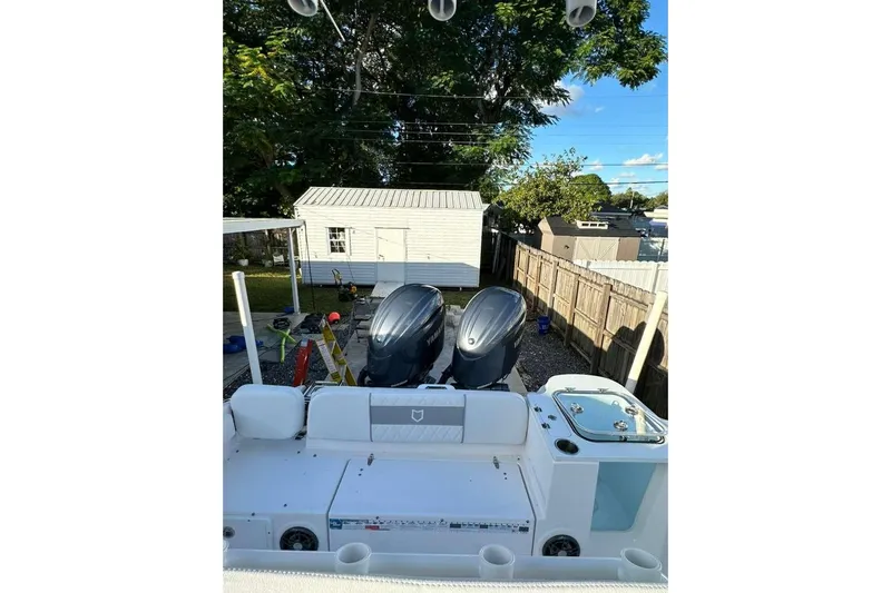  Yacht Photos Pics 2024 Sea Fox 268 Commander boat with dual engines in a backyard setting.