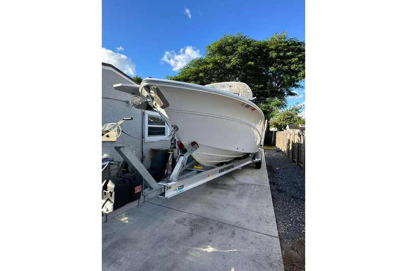  Yacht Photos Pics 2024 Sea Fox 268 Commander boat on trailer, parked in driveway under clear blue sky.