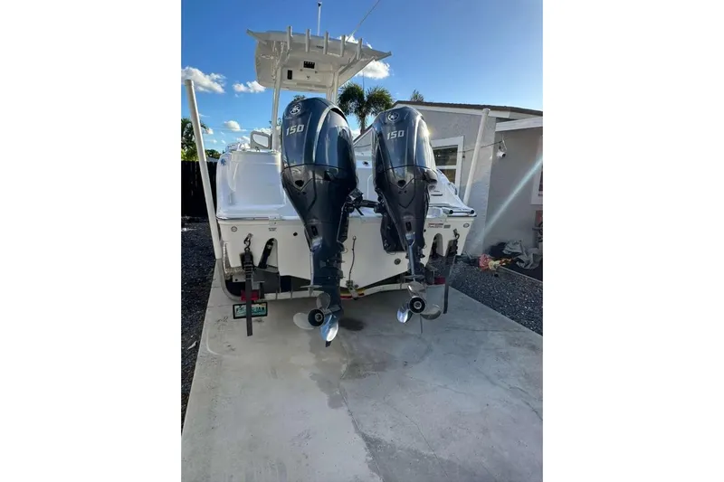  Yacht Photos Pics 2024 Sea Fox 268 Commander with dual 150 horsepower outboard engines, parked on concrete.