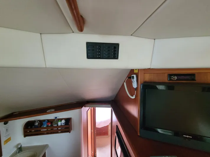  Yacht Photos Pics Interior of 2002 Riviera 37 Convertible yacht with TV and control panel.
