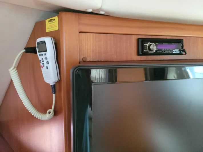  Yacht Photos Pics Interior of 2002 Riviera 37 Convertible with mounted TV and remote control.