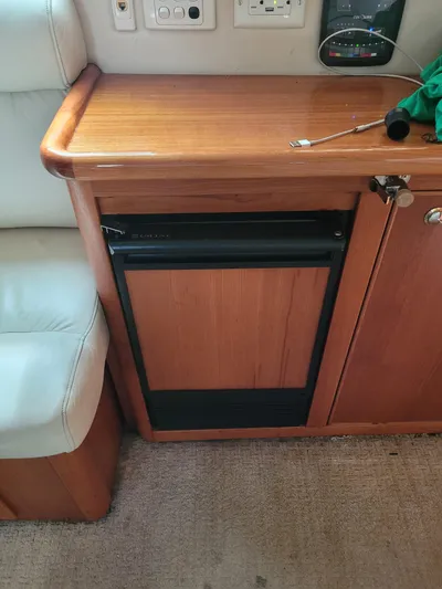  Yacht Photos Pics 2002 Riviera 37 Convertible interior with wooden cabinetry and compact refrigerator.