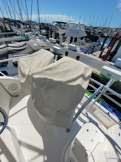  Yacht Photos Pics 2002 Riviera 37 Convertible yacht at marina, covered seats, sunny day.