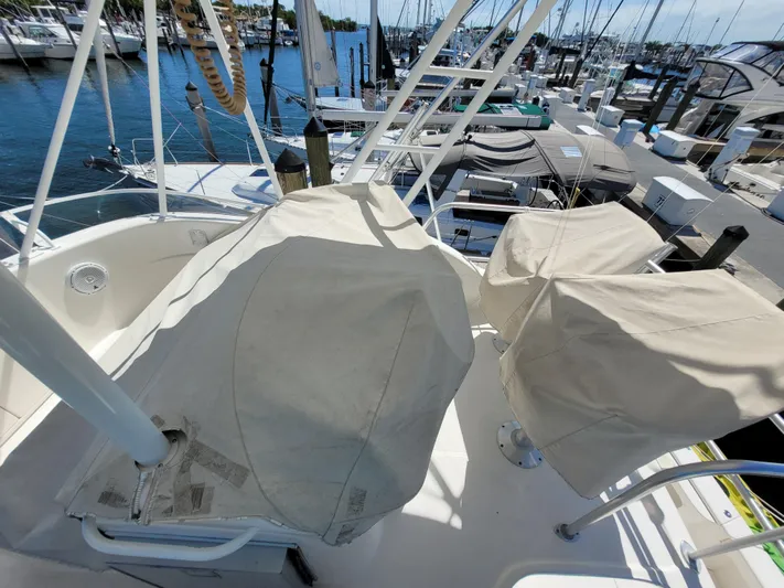  Yacht Photos Pics 2002 Riviera 37 Convertible yacht with covered seating at a marina.