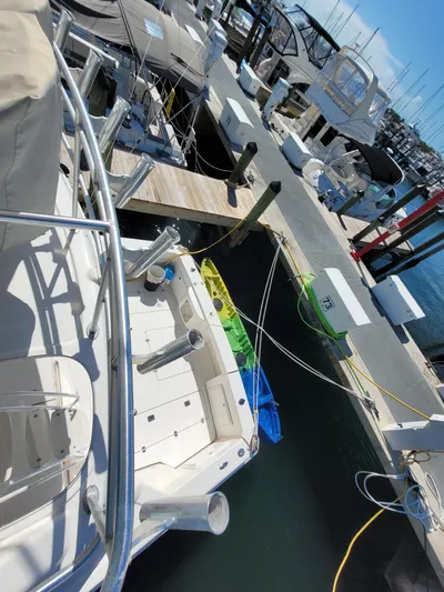  Yacht Photos Pics 2002 Riviera 37 Convertible yacht docked at marina, surrounded by other boats.