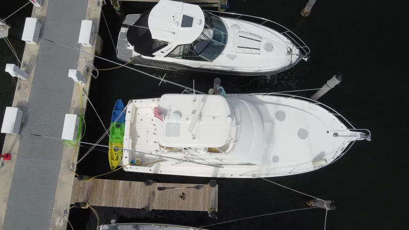  Yacht Photos Pics Aerial view of a 2002 Riviera 37 Convertible yacht docked at a marina.