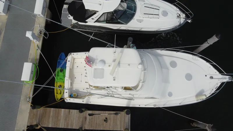  Yacht Photos Pics Overhead view of a 2002 Riviera 37 Convertible yacht docked beside another boat.