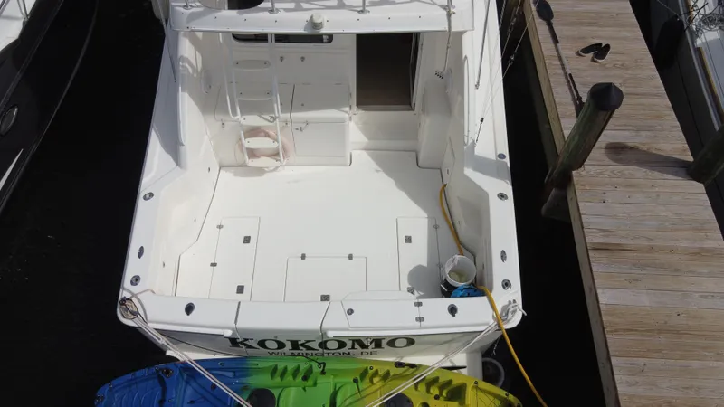  Yacht Photos Pics 2002 Riviera 37 Convertible boat docked, view of spacious deck and colorful kayaks.