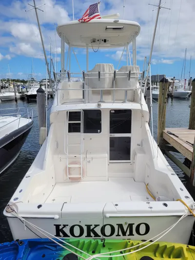  Yacht Photos Pics 2002 Riviera 37 Convertible boat named "Kokomo" docked at a marina.