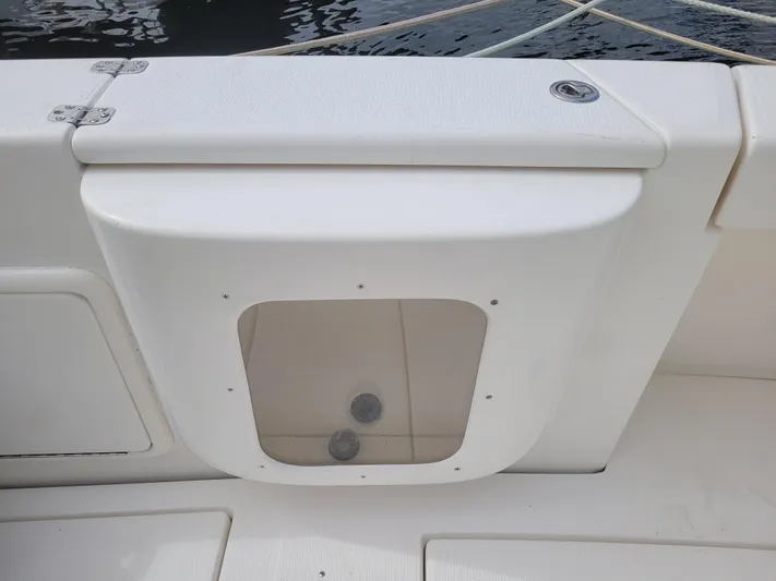  Yacht Photos Pics Riviera 37 Convertible 2002 boat deck with storage compartment and water view.