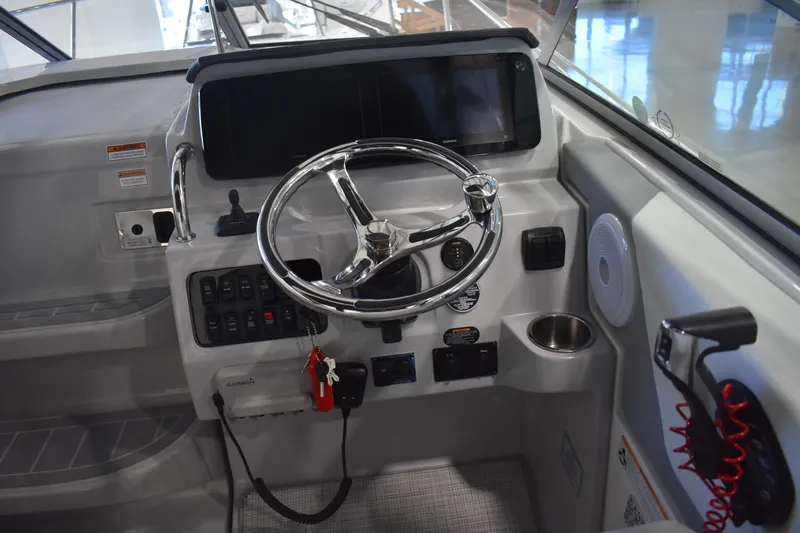  Yacht Photos Pics 2026 Regal 26 XO boat dashboard with steering wheel and control panel.