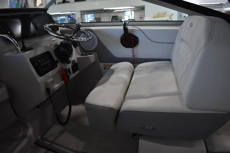  Yacht Photos Pics Interior of 2026 Regal 26 XO boat with steering wheel and cushioned seating.