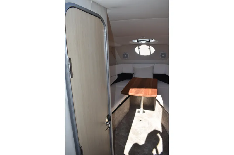  Yacht Photos Pics 2026 Regal 26 XO cabin interior with table and seating, modern design.