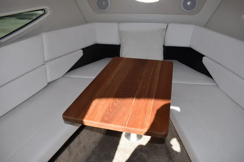  Yacht Photos Pics Interior of 2026 Regal 26 XO boat with wooden table and white seating.