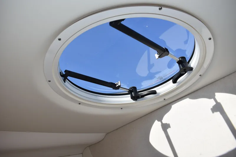  Yacht Photos Pics Round window on 2026 Regal 26 XO boat, showcasing blue sky view.
