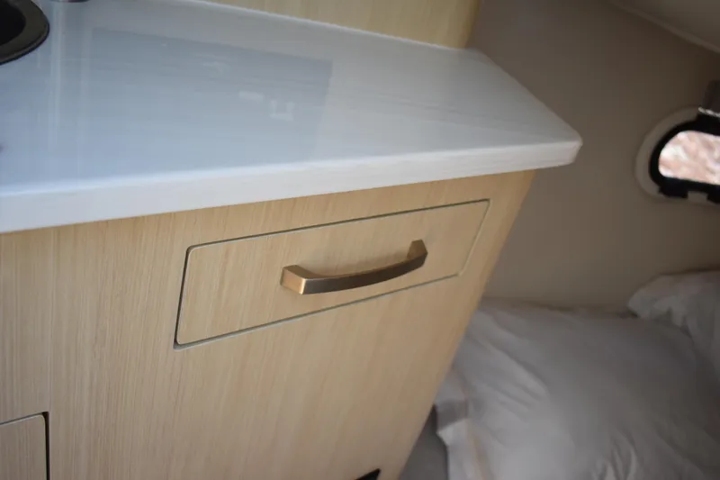  Yacht Photos Pics 2026 Regal 26 XO interior with wooden cabinet and sleek countertop.