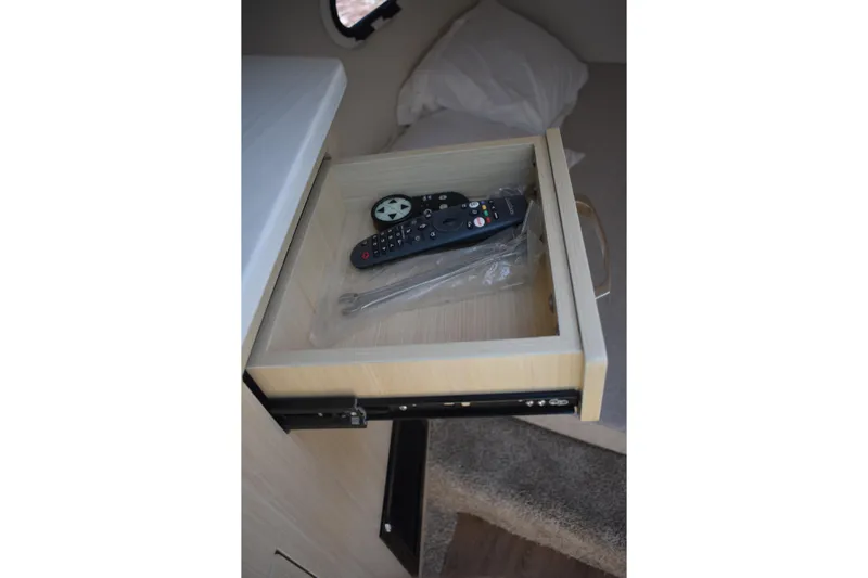  Yacht Photos Pics Open drawer in 2026 Regal 26 XO boat cabin with remote control inside.