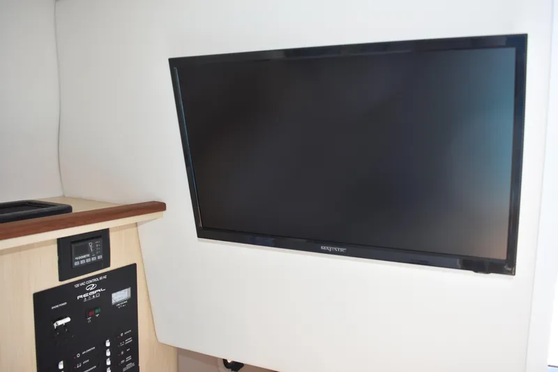  Yacht Photos Pics 2026 Regal 26 XO interior with wall-mounted TV and control panel.