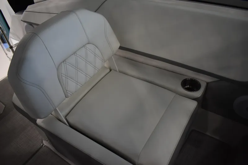  Yacht Photos Pics 2026 Regal 26 XO boat seat with cup holder, featuring elegant white upholstery.