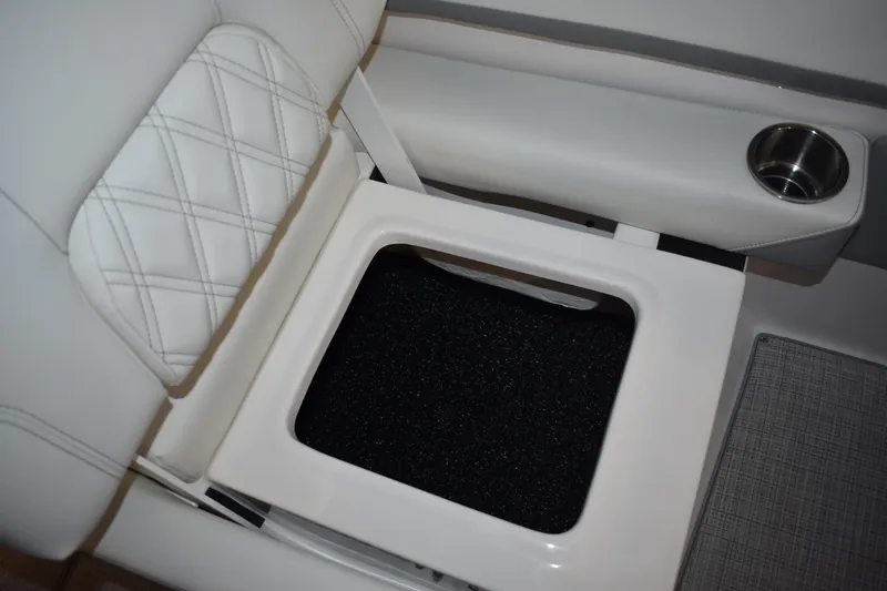  Yacht Photos Pics 2026 Regal 26 XO boat interior with white cushioned seating and built-in cup holder.