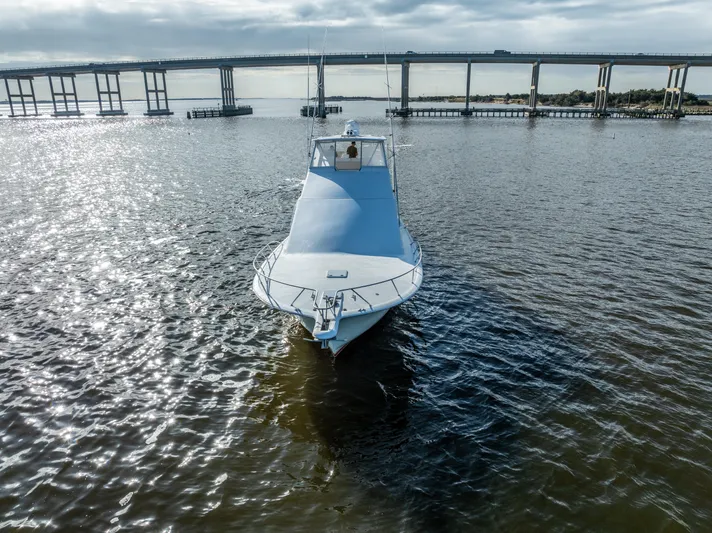  Yacht Photos Pics Ocean 57 yacht from 2006 on a calm river near a bridge.