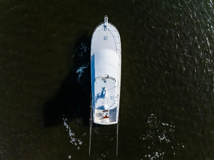  Yacht Photos Pics Aerial view of 2006 Ocean 57 yacht cruising on dark water.