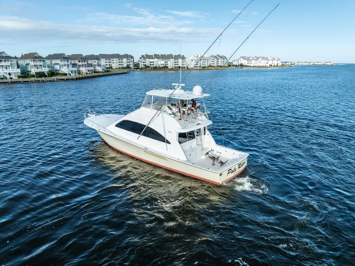  Yacht Photos Pics 2006 Ocean 57 yacht cruising near coastal homes on a sunny day.