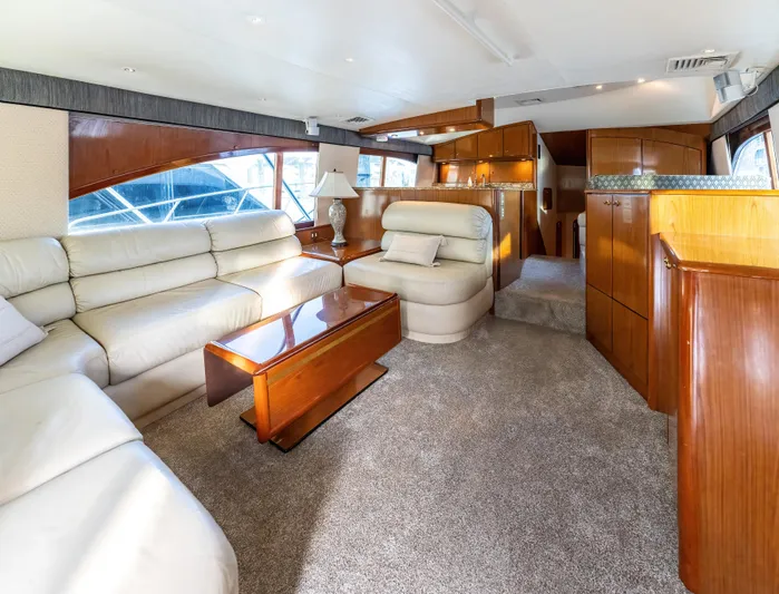  Yacht Photos Pics Luxurious interior of 2006 Ocean 57 yacht with plush seating and wooden accents.
