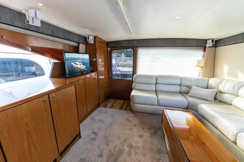  Yacht Photos Pics Luxurious 2006 Ocean 57 yacht interior with plush seating and wooden cabinetry.