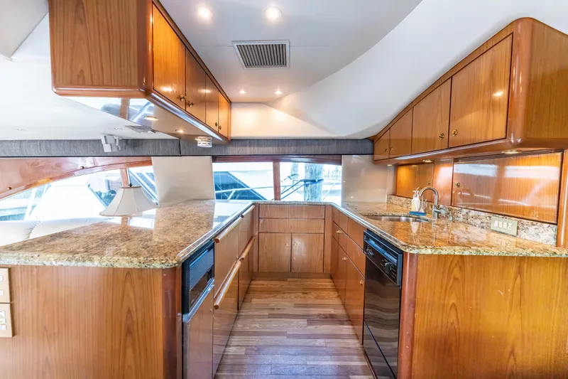  Yacht Photos Pics Luxurious 2006 Ocean 57 yacht kitchen with wood cabinets and granite countertops.