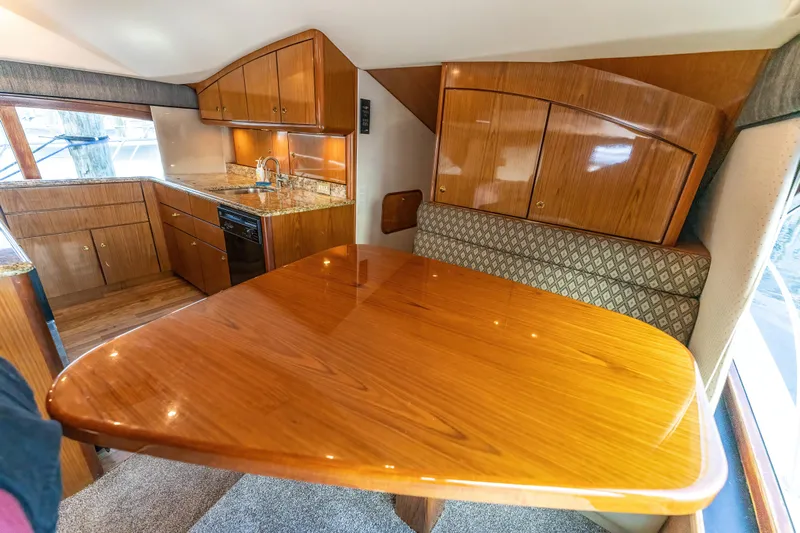  Yacht Photos Pics Luxurious 2006 Ocean 57 yacht interior with polished wood dining area and modern kitchen.