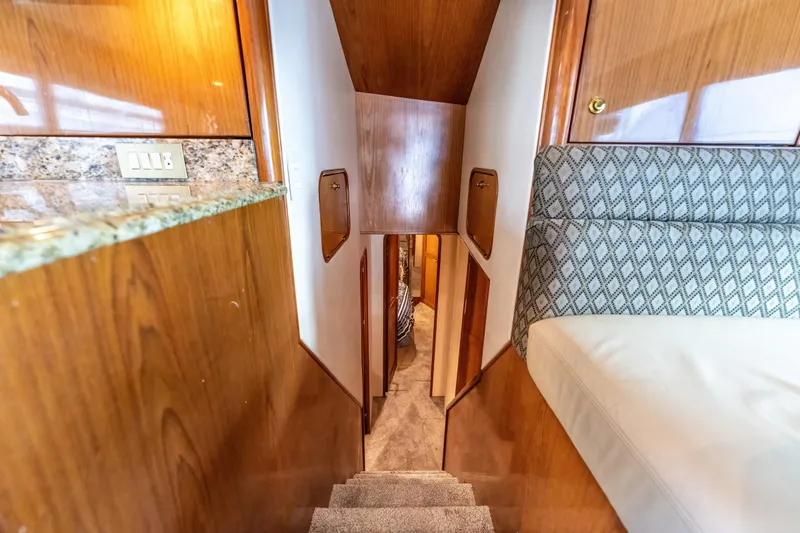 Yacht Photos Pics Interior of 2006 Ocean 57 yacht with wooden finishes and carpeted stairs.