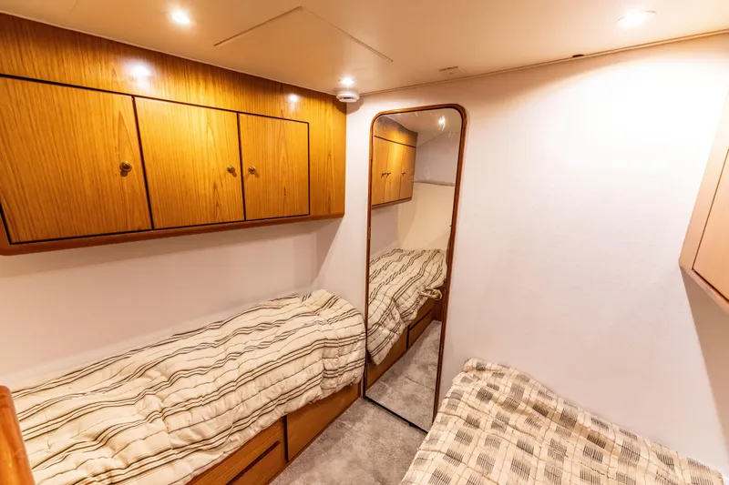  Yacht Photos Pics Cozy cabin interior of 2006 Ocean 57 yacht with twin beds and wooden cabinets.