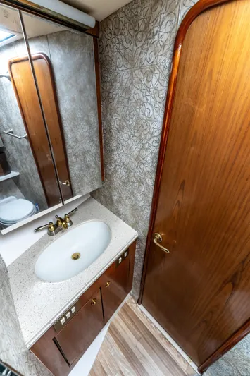  Yacht Photos Pics Luxurious bathroom in 2006 Ocean 57 yacht with wood accents and modern fixtures.