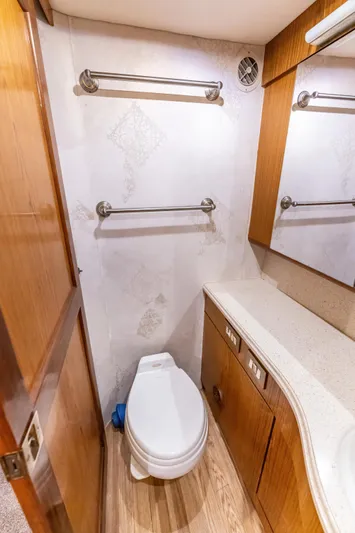  Yacht Photos Pics Bathroom interior of 2006 Ocean 57 yacht with wooden accents and modern fixtures.