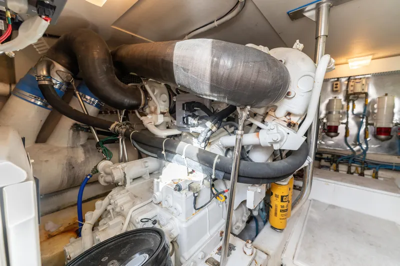  Yacht Photos Pics Engine room of a 2006 Ocean 57 yacht, showcasing mechanical components and piping.