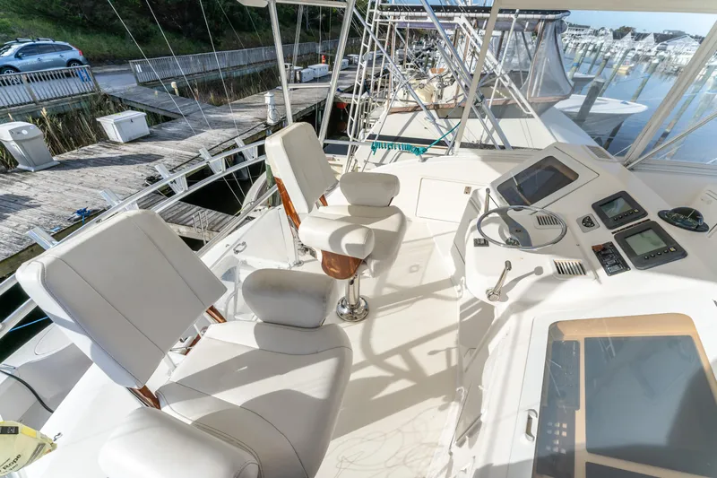  Yacht Photos Pics 2006 Ocean 57 yacht helm with white seating and navigation equipment at marina.