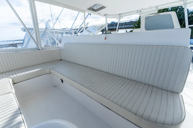  Yacht Photos Pics Luxurious seating area on a 2006 Ocean 57 yacht, featuring white cushioned benches.