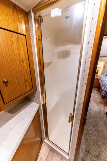  Yacht Photos Pics Luxurious bathroom shower in 2006 Ocean 57 yacht with wooden cabinetry.