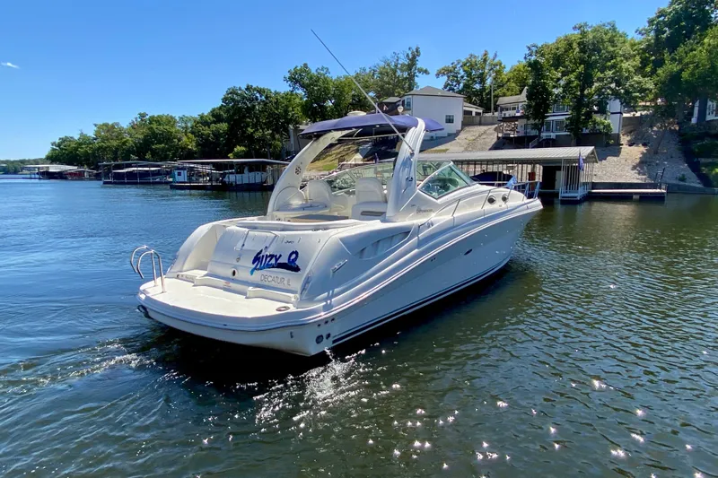  Yacht Photos Pics 2007 Sea Ray 340 Sundancer boat on a sunny lake with docked houses.