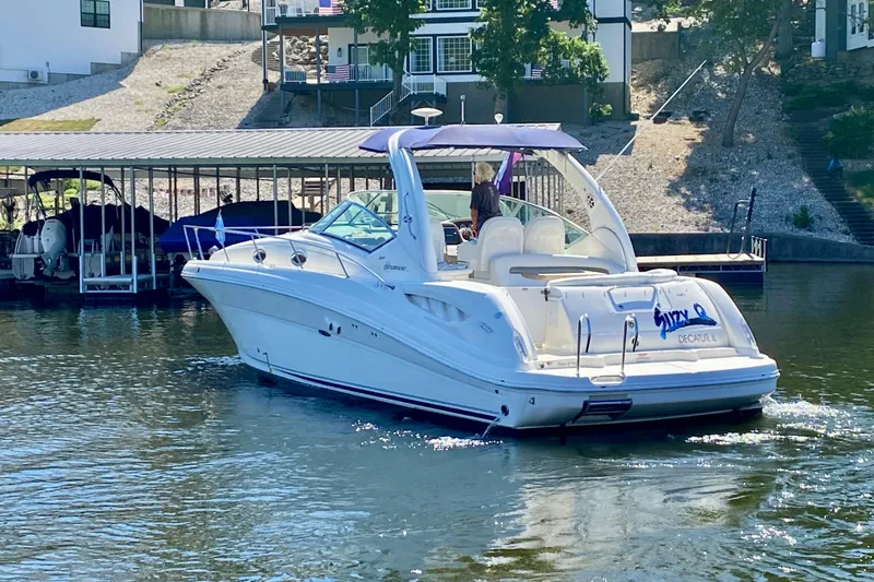  Yacht Photos Pics 2007 Sea Ray 340 Sundancer boat cruising on a sunny day near a dock.