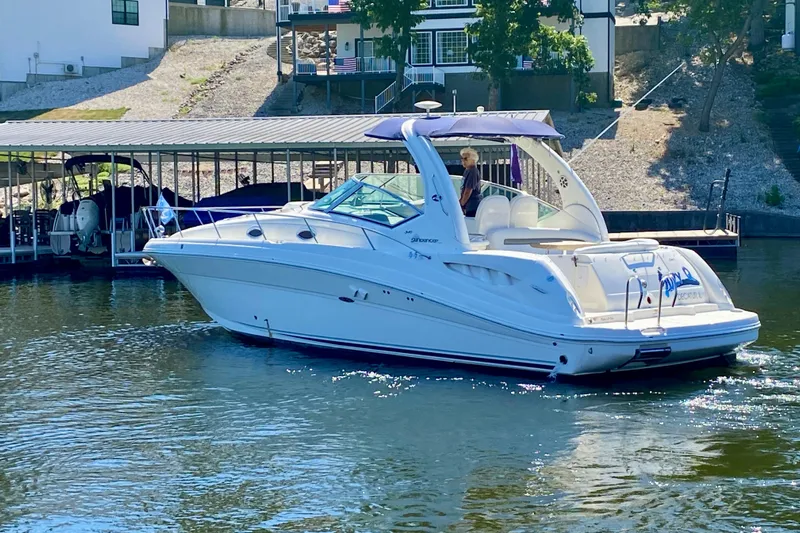  Yacht Photos Pics 2007 Sea Ray 340 Sundancer yacht cruising on a sunny day near a dock.