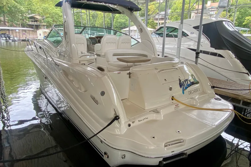  Yacht Photos Pics 2007 Sea Ray 340 Sundancer docked in a marina, showcasing sleek design and spacious seating.