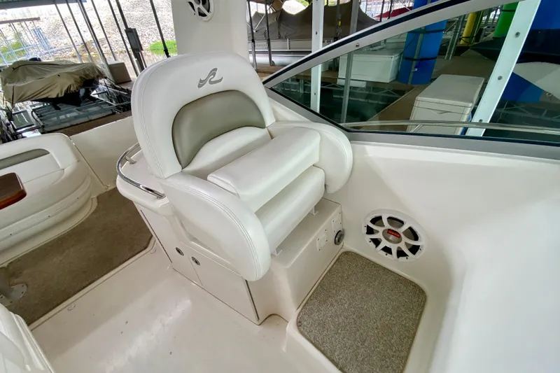  Yacht Photos Pics Captain's seat on 2007 Sea Ray 340 Sundancer, featuring white upholstery and speaker.