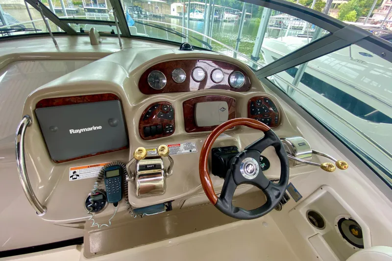  Yacht Photos Pics Control panel of a 2007 Sea Ray 340 Sundancer boat with steering wheel and navigation equipment.
