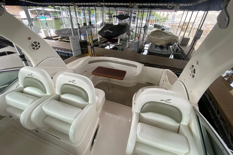  Yacht Photos Pics 2007 Sea Ray 340 Sundancer interior with white seating and wooden table in marina.