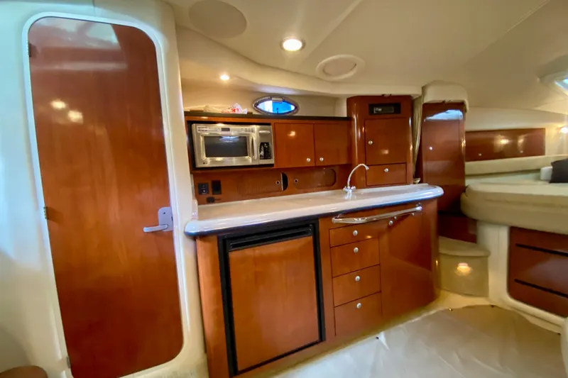 Yacht Photos Pics Interior of 2007 Sea Ray 340 Sundancer yacht with kitchenette and wood cabinetry.