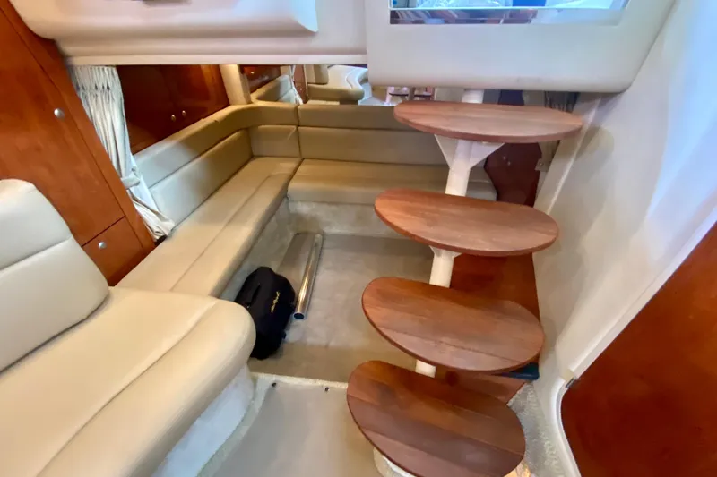  Yacht Photos Pics Interior of 2007 Sea Ray 340 Sundancer with wooden steps and beige seating.