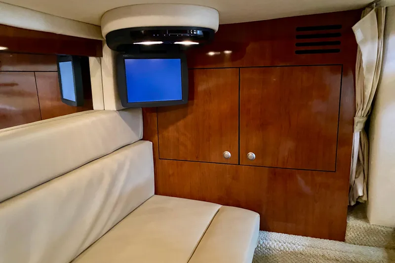  Yacht Photos Pics Interior of 2007 Sea Ray 340 Sundancer with wood paneling and mounted TV.