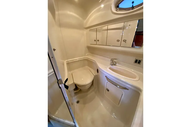  Yacht Photos Pics 2007 Sea Ray 340 Sundancer bathroom with sink, toilet, and storage cabinets.